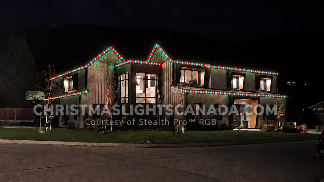 Contemporary home with Stealth Pro Ultra™ permanent RGB+W roofline lighting illuminated at night